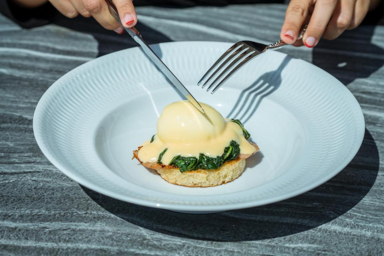 El Llorenc Parc De La Mar - Adults Only Palma de Mallorca Bagian luar foto A poached egg being cut with a knife and fork